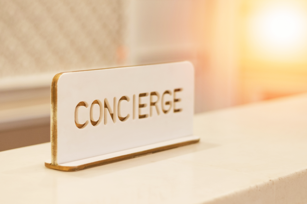 Concierge service sign at hotel front desk.