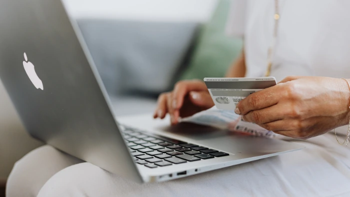 Woman buying a family vacation online at a discount.