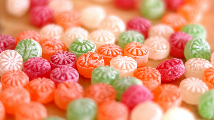 Decorate gingerbread houses with candy.