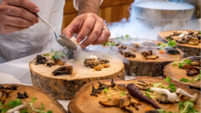 Fancy dinner being prepared by a chef at a resort.