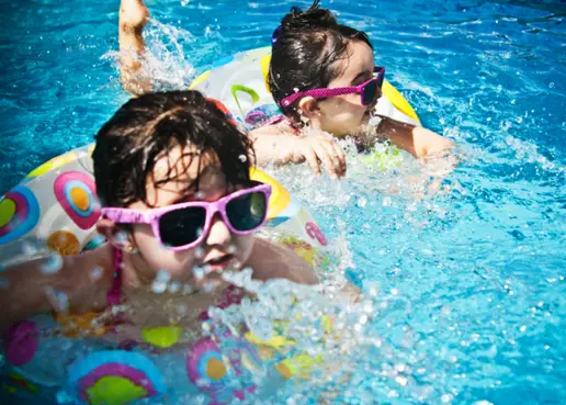 Girls swimming at an all-inclusive resort where kids stay free of charge.