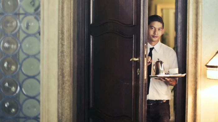 Hotel employee delivering room service