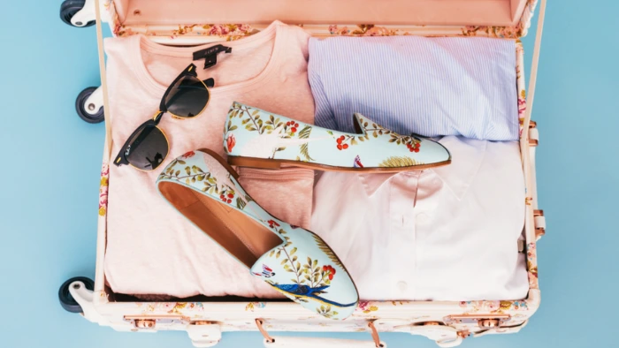 Woman's packed suitcase for a beach holiday.