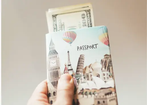 Passport with money representing savings that staying at an all-inclusive resort offers.