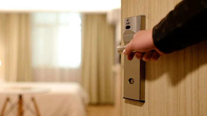 Hotel staff opening door to secret hospitality suite.